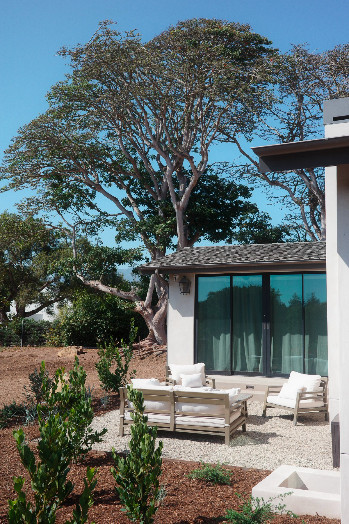 Hope Ranch side patio beneath a mature tree
